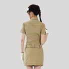 Woman wearing a beige dress with a white logo on a light gray background