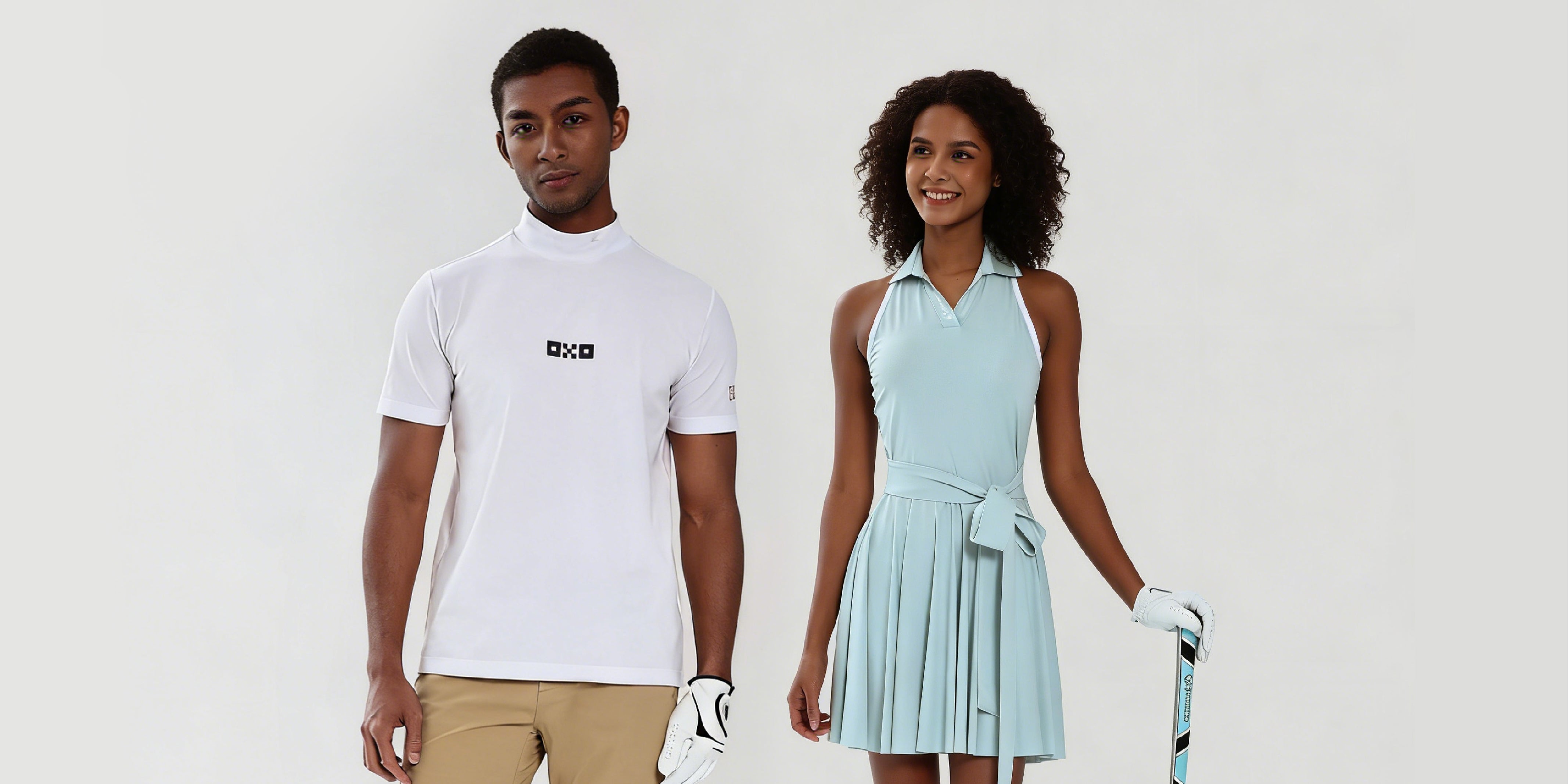Two people, one in a white t-shirt and beige pants, the other in a light blue dress with a tennis racket, on a plain background.